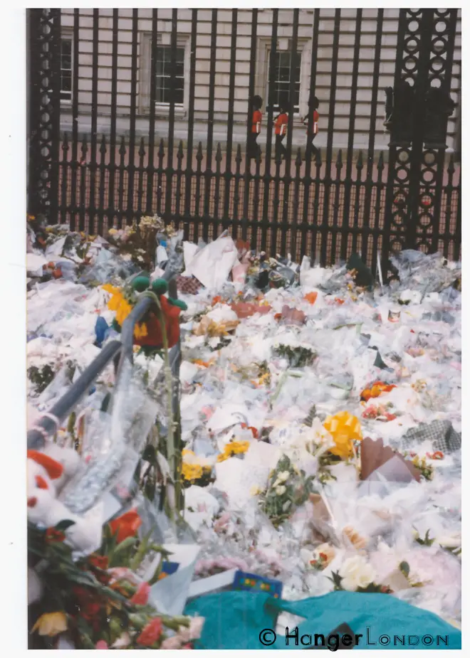 Floral Tributes laid in sympathy for Princess Diana Outside Buckingham Palace. The 3 guards on duty, providing some familiar structural normality to what seemed a slowed down space of uncertainty in time. September 1997