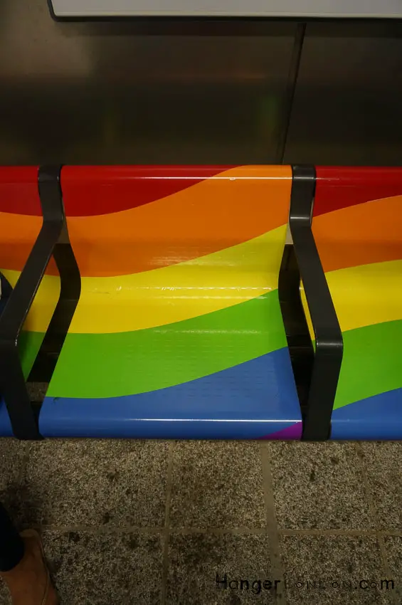 Shoreditch High street tube platform chairs in the colours of the Rainbow Flag for Pride London 2018