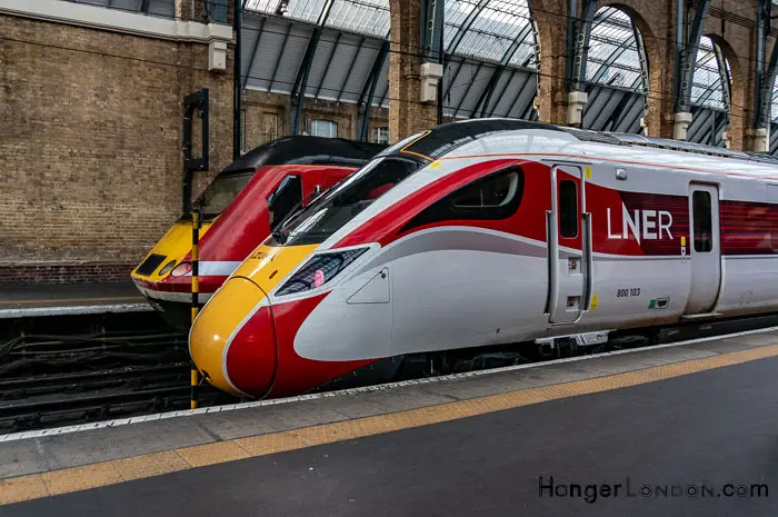 Yellow and Red nose of Azuma Train next to Intercity sitting at Kings Cross St Pancras Station