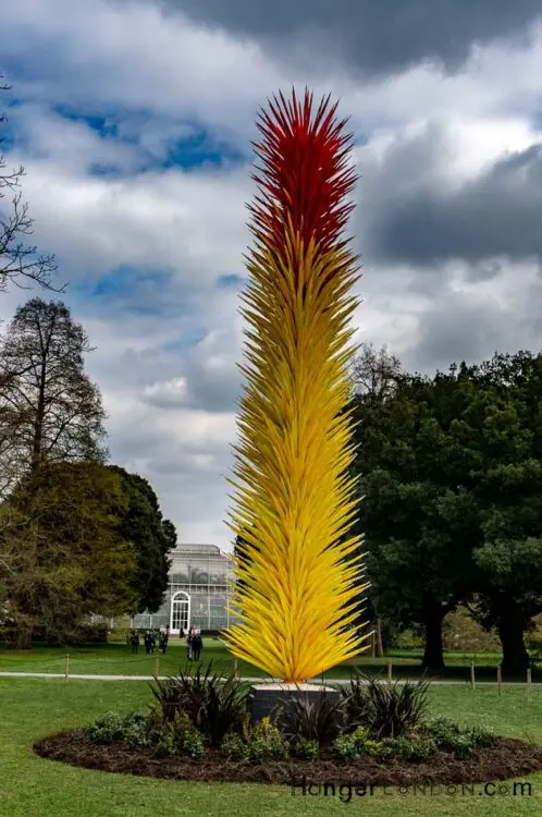 A yellow and red tall plume of spikes made out of glass chihuly Kew